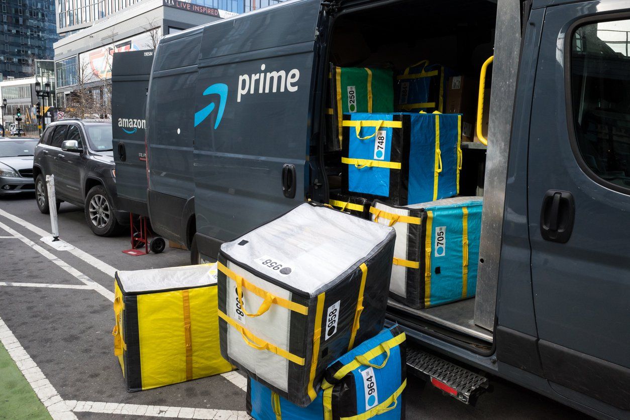 a photo of Amazon truck unloading packages.