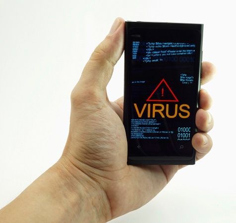 a man's hand with smartphone in it sowing virus warning,.