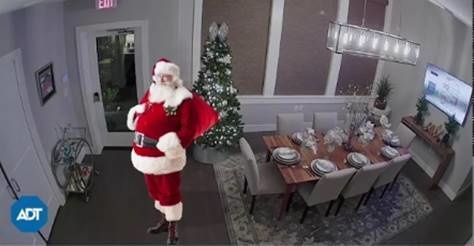 An augmented image of Santa Claus in a living room made to look like security footage