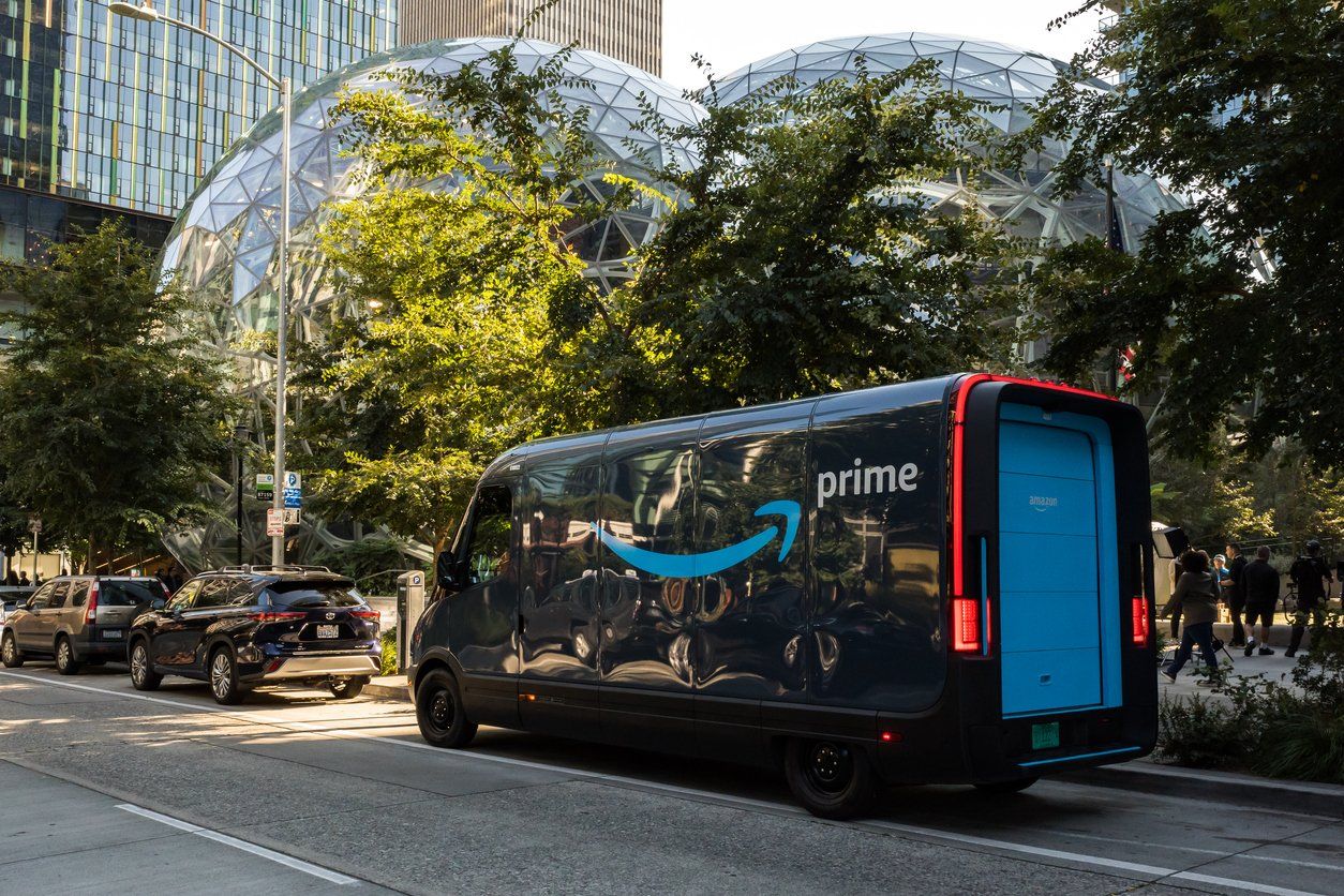 a photo of an Amazon EV truck parked on the street.