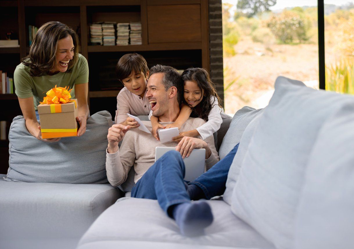 a photo of a family on the couch celebrating father's day.