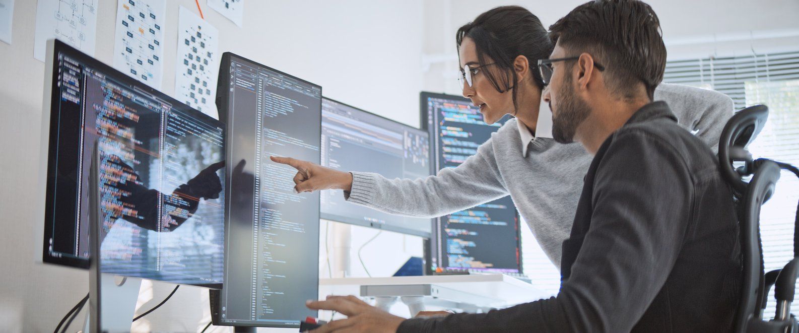 Hispanic Latin American couple, software engineer developer use computer, work on program coding together at home office. Programming language development technology, freelance job concept stock photo