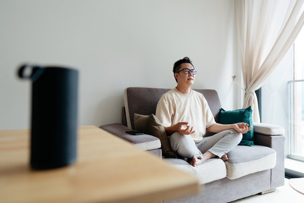 Home meditation with smart speaker stock photo