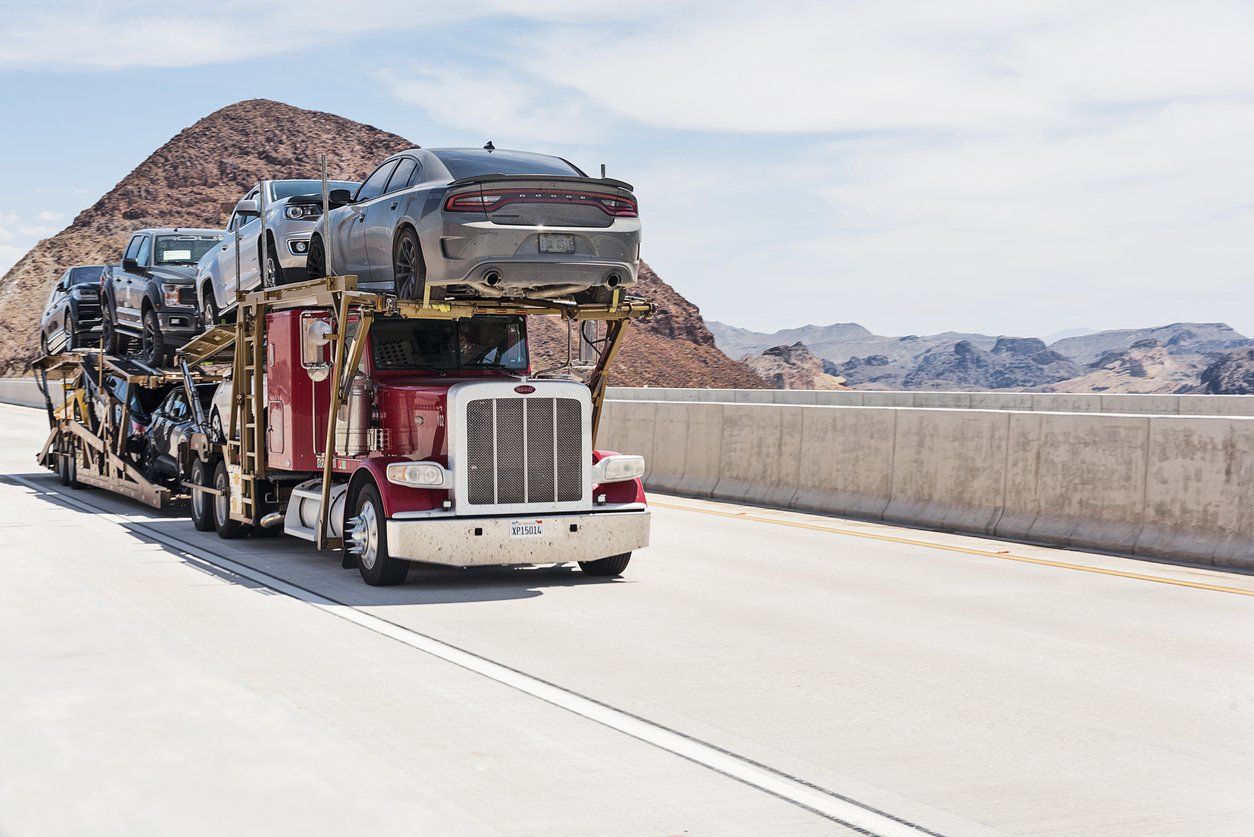 a photo of a auto shipping truck on the highway