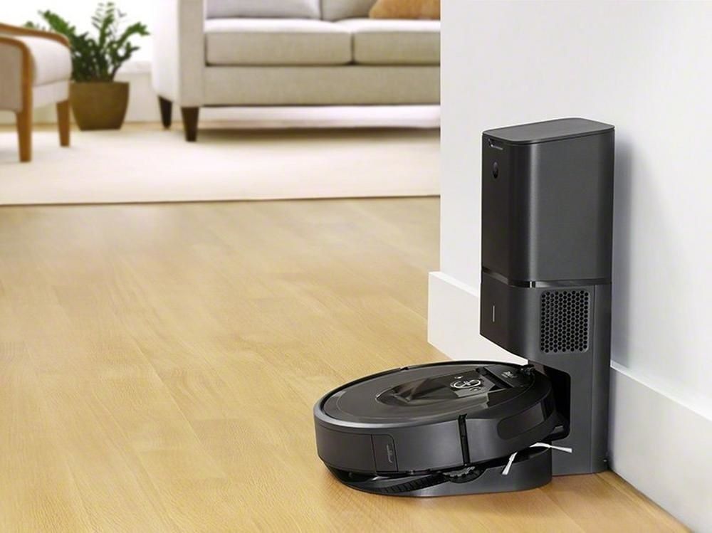 a photo of a iRobot roomba charging on a self-emptying station