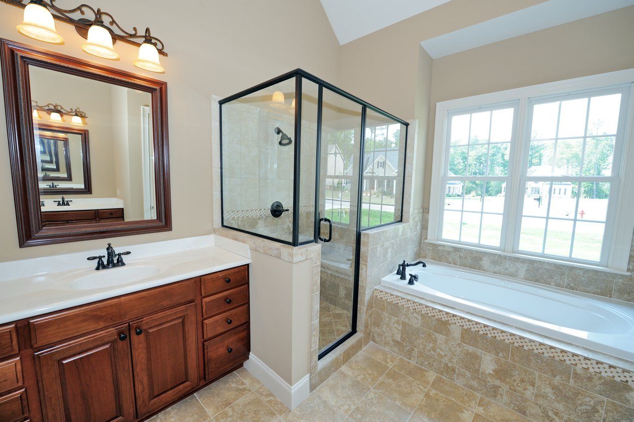 a photo of a bathroom with frameless doors