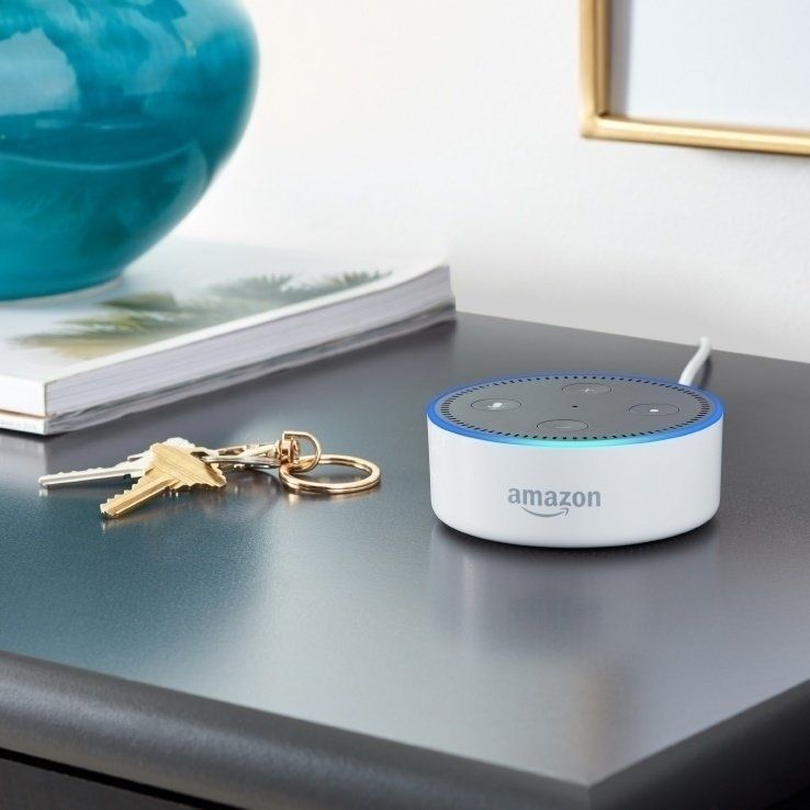 a photo of amazon echo dot 2nd gen smart speaker and a set of keys on a desk