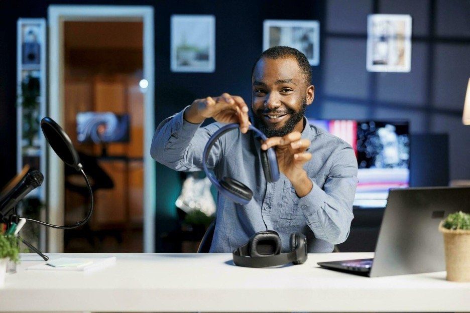 a man holding headphones in a podcast studio