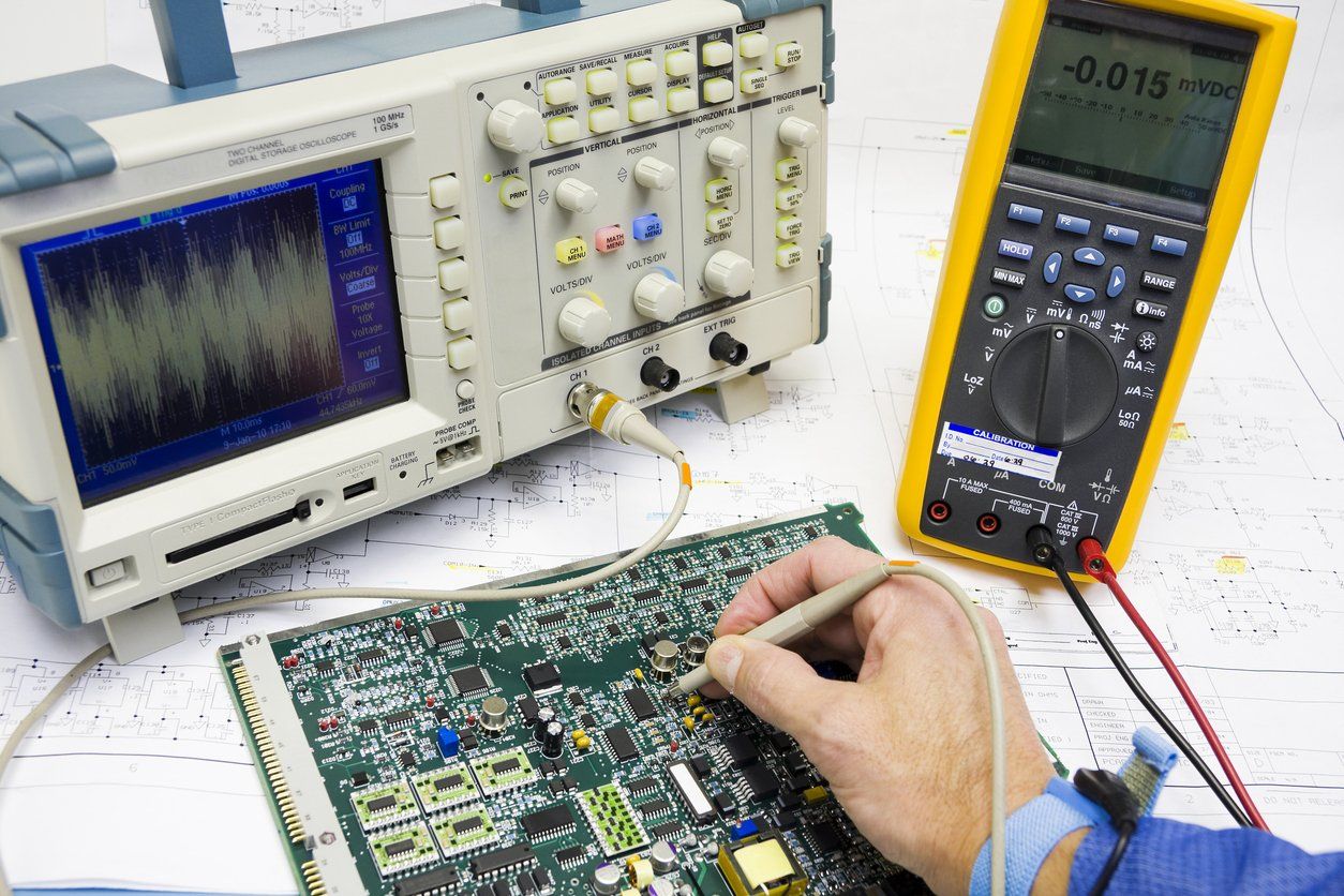 A man wearing an ESD band troubleshoots electronic circuits stock photo