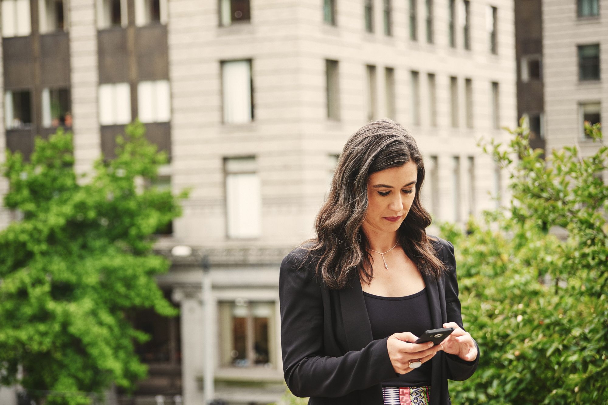 a woman on her smartphone outside photo