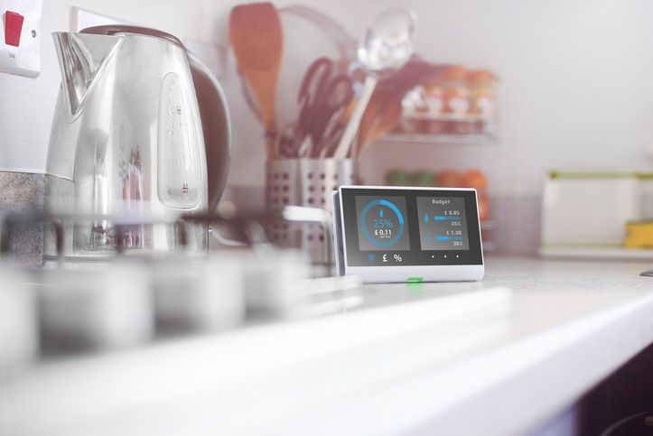 Kitchen kettle with a smart video screen next to it