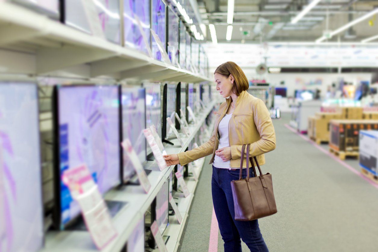 a woman shopping for a TV