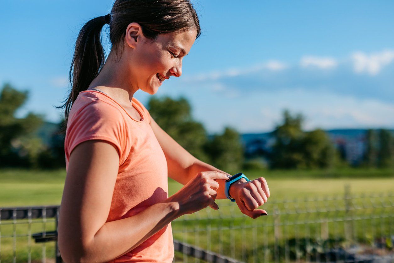 Young Woman Checking Pulse On Her Smartwatch After Exercising stock photo