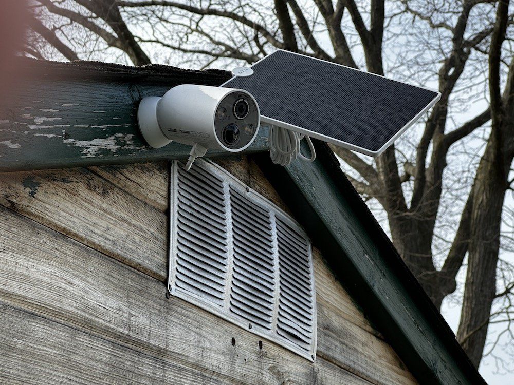 a photo of TP-Link Tapo TC85 Wire-Free Security Camera and Tapo Solar panel on a shed