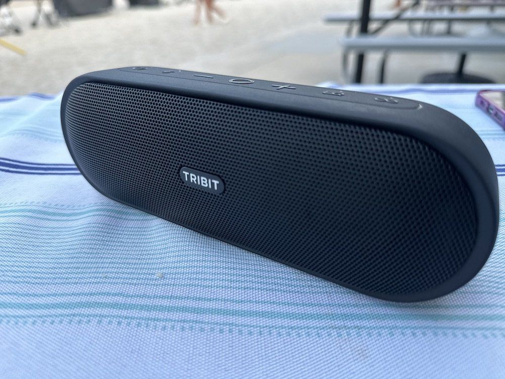 a photo of Tribit XSound Plus 2 Portable Wireless Speaker on a table at the beach