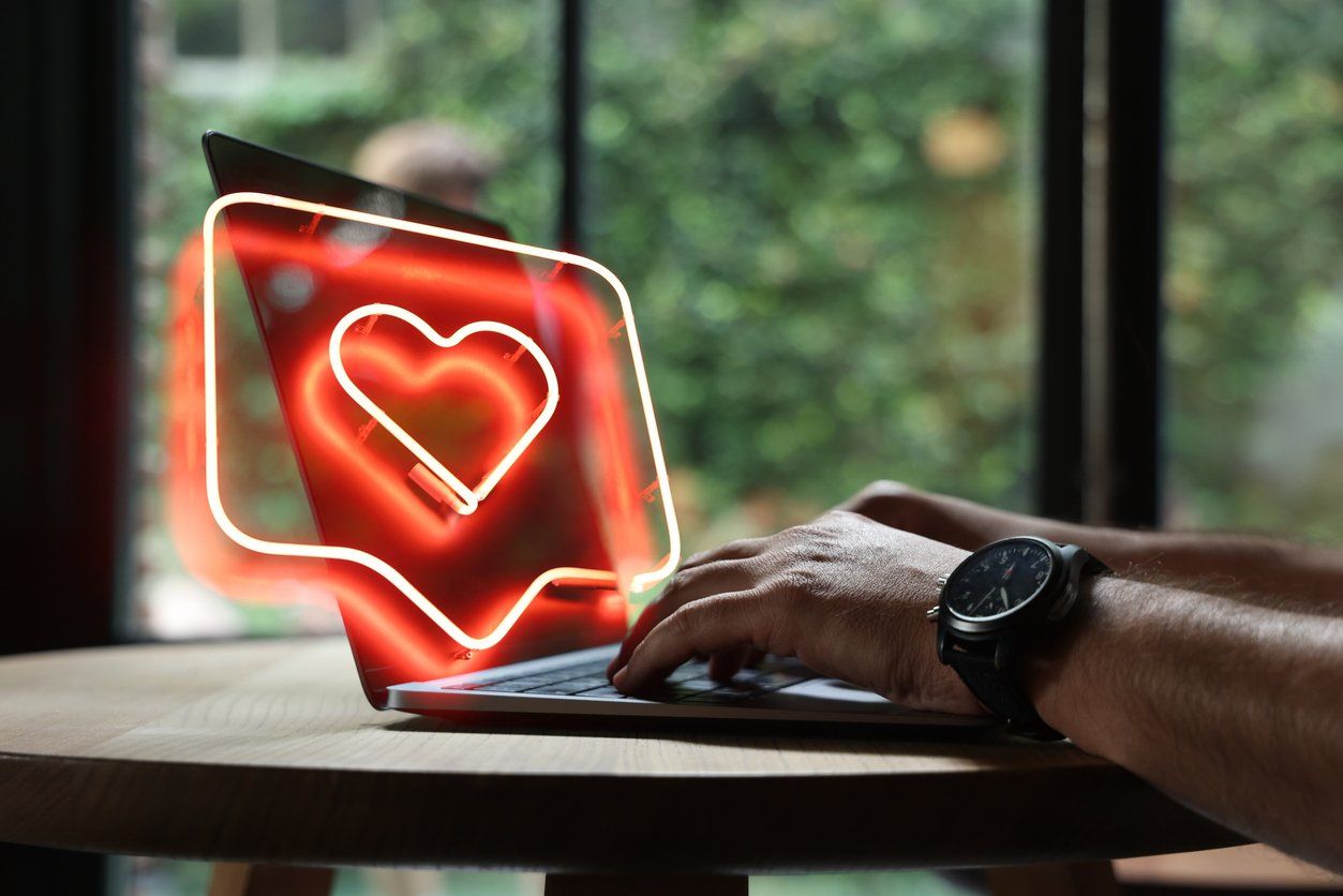 Man using laptop with heart shape stock photo