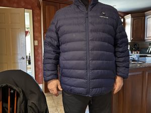 a photo of a male wearing a Venustas Men’s Heated Lightweight Puffer Jacket 7.4V