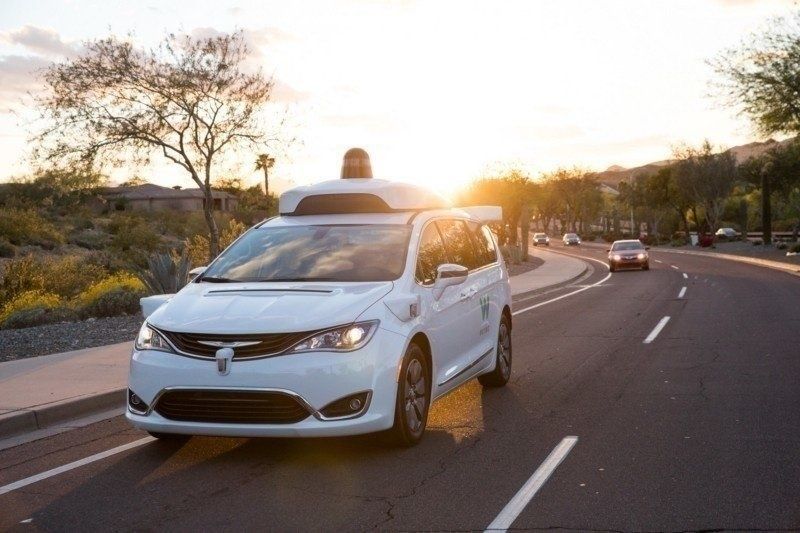 a photo of waymo driverless taxi on the road.