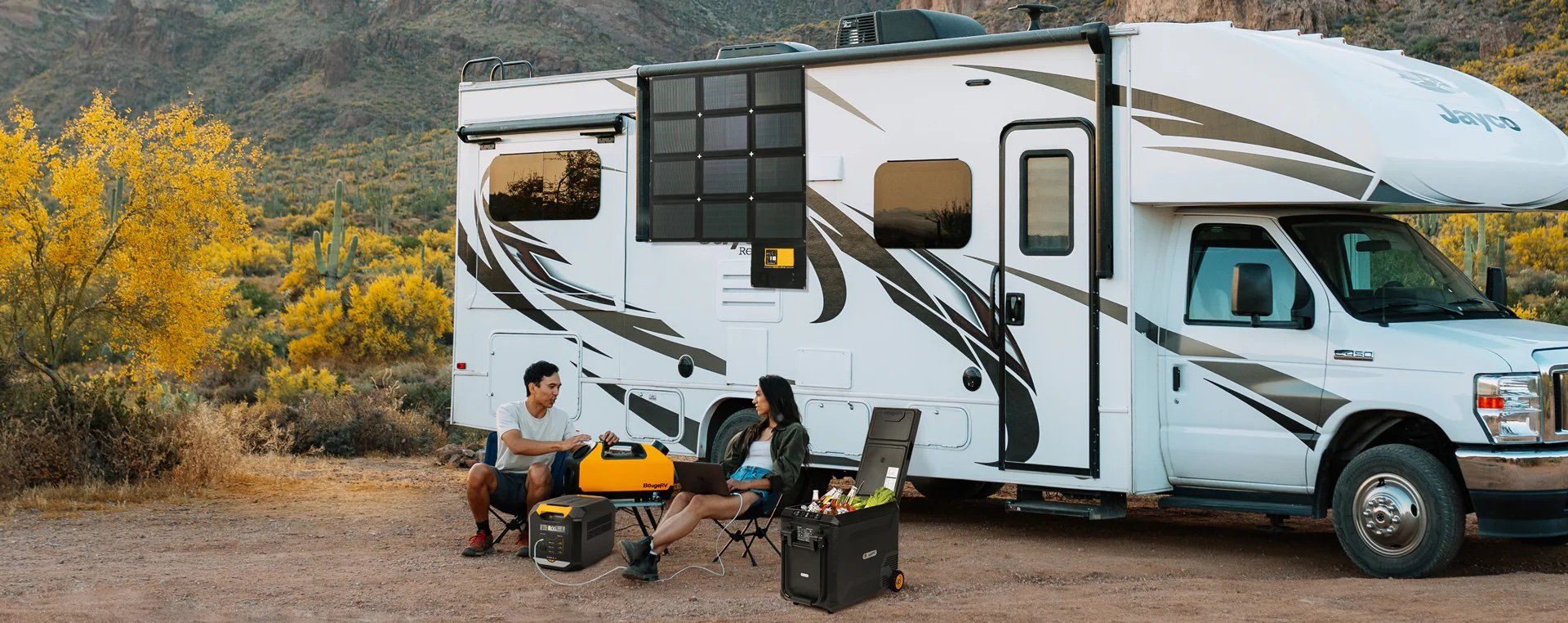 People sitting outside with their RV using BougeRV devices at a camp site.