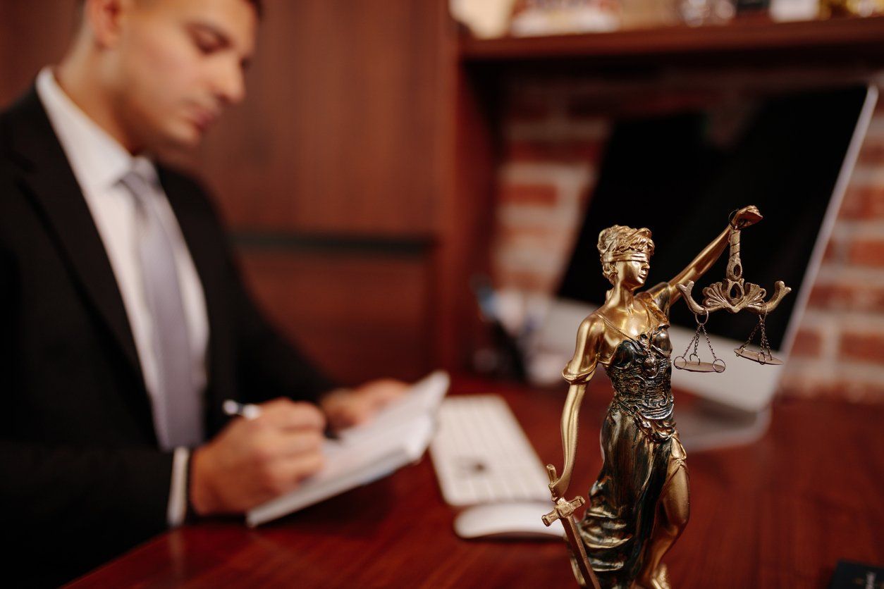 a photo of an attorney working at his desk in his office.