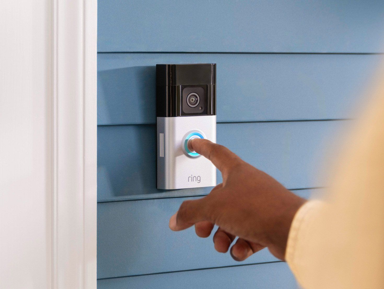 a person pressing the button on a Ring Video Doorbell