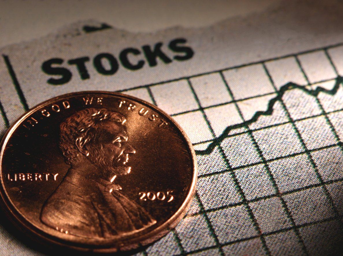 a photo of a penny on top of a stock sheet