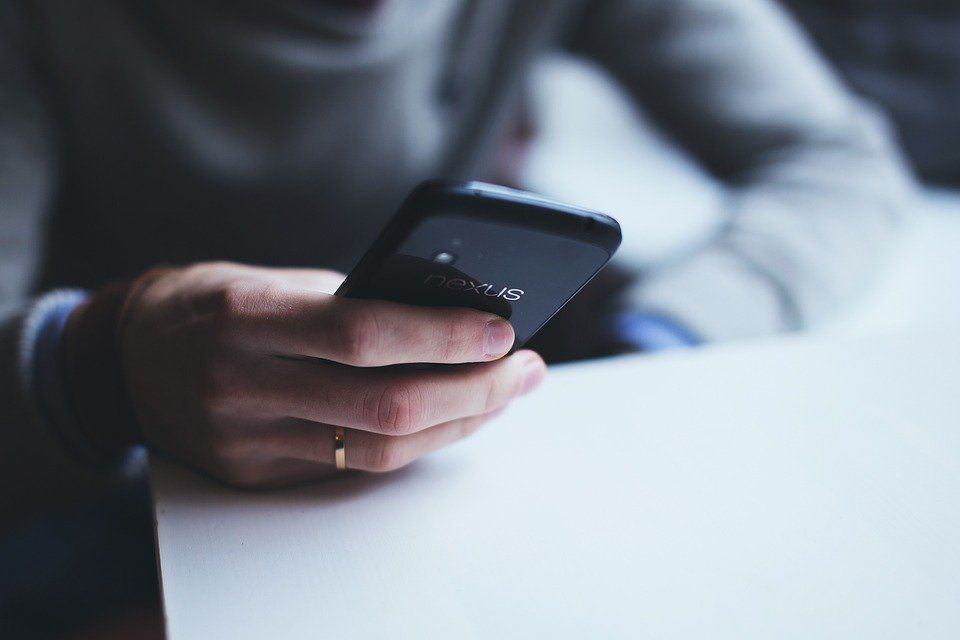 a woman holding a smartphone in her hand