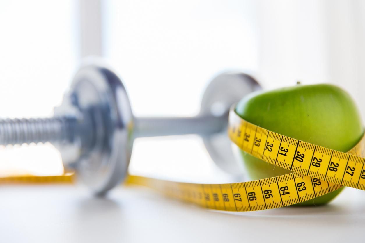 a photo of a tape measure and dumbell