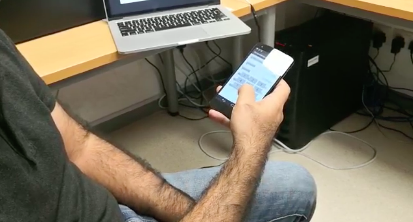 a photo of a man on. his smartphon entering a pin code