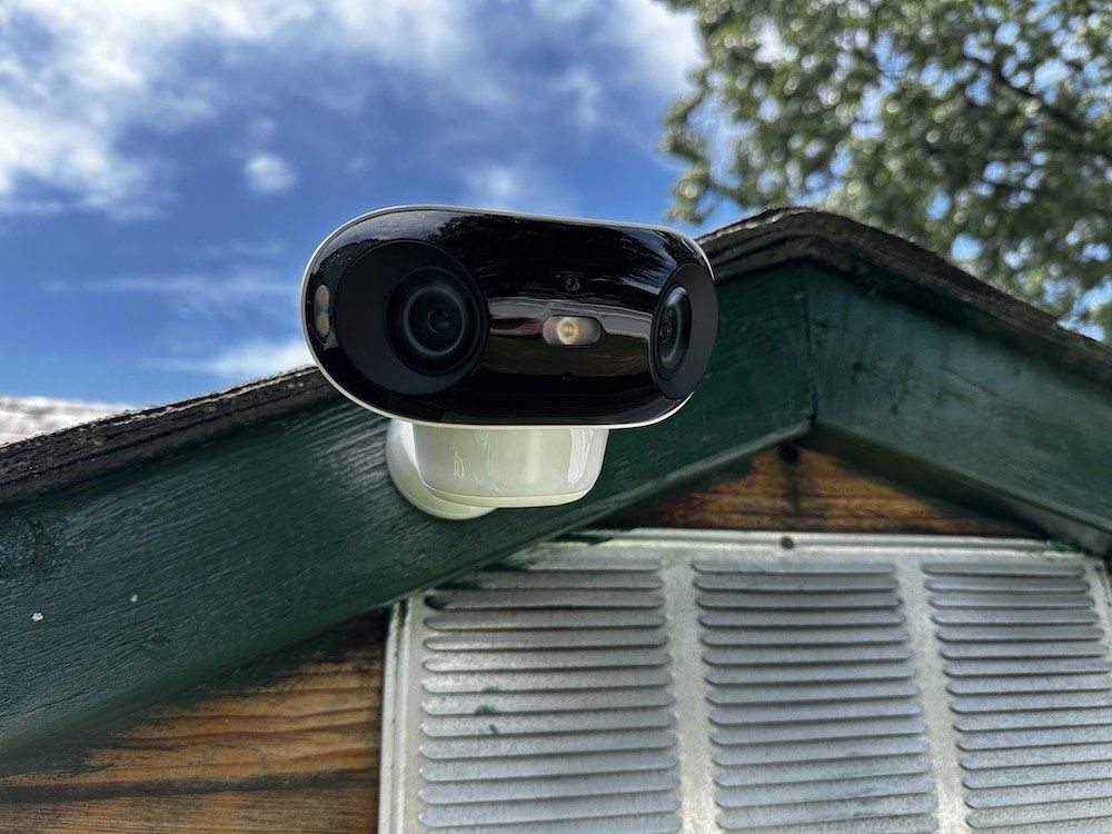 a photo of Reolink Argus 4 Pro installed outside on a shed during the day.